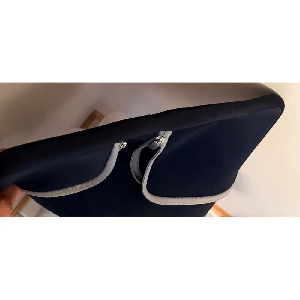 Black laptop sleeve bag features gray zipper compartment carrying handle.